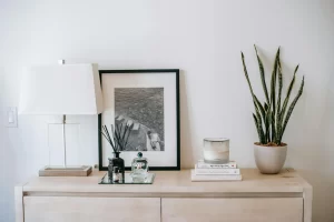 candle and scent diffuser sticks on table in apartment