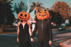 couple wearing pumpkin heads the reef blog