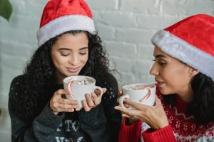 two girls drinking cocoa holiday traditions the reef blog